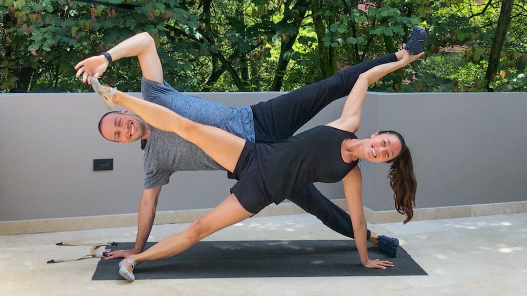 Two young women doing partner yoga asana downward facing dog. Adho Mukha  Svanasana Stock Photo - Alamy